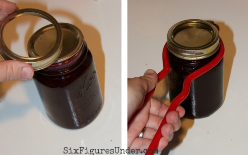 Put your hot flat lid on your clean jar rim, then screw on the ring. Use the jar wrench to hold the hot jar and screw the band on tightly